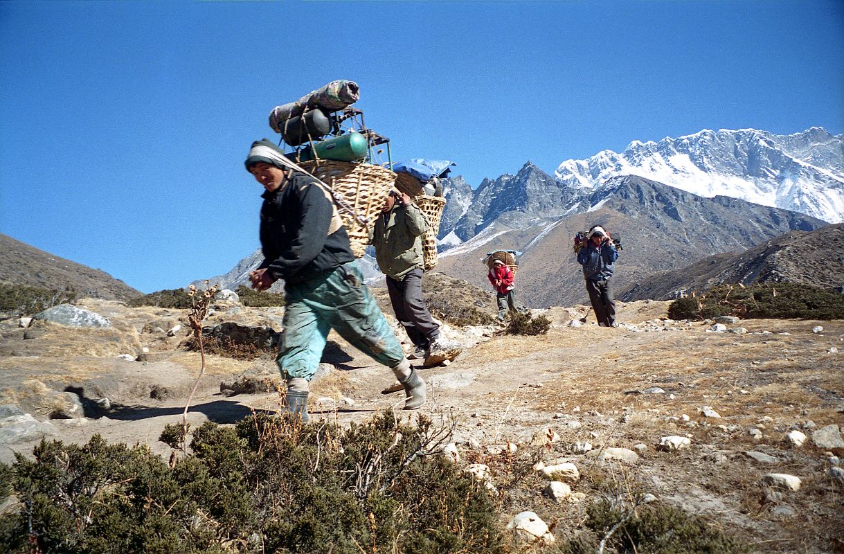 11 Tengboche To Dingboche - Porters Rushing Downhill With Nuptse South Face